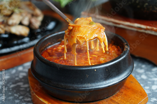 Kimchi Soup with tofu and pork belly served in clay pot, One of the most loved of all the stews in Korean cuisine, Most popular food in Korea. photo