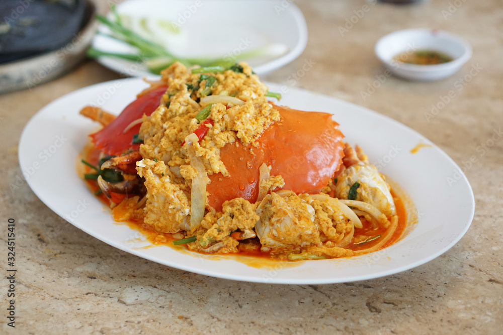 Stir-Fried Sea Crab with Curry Powder Sauce, Milk and Eggs. A popular Thai-Chinese seafood recipe. Stir-Fried Sea Crab with Curry Powder Sauce, Milk and Eggs. A popular Thai-Chinese seafood recipe.