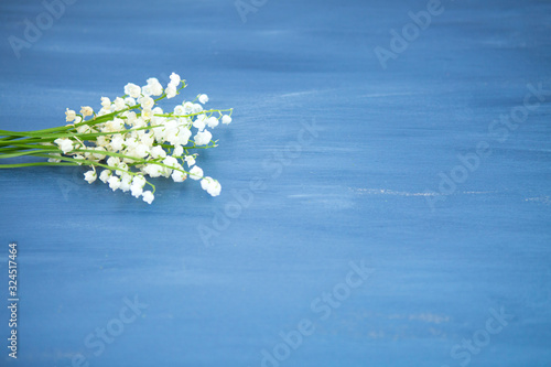 Wonderful fragrant white flowers with a delicate scent. Lily of the valley flowers on gray wooden or metal table