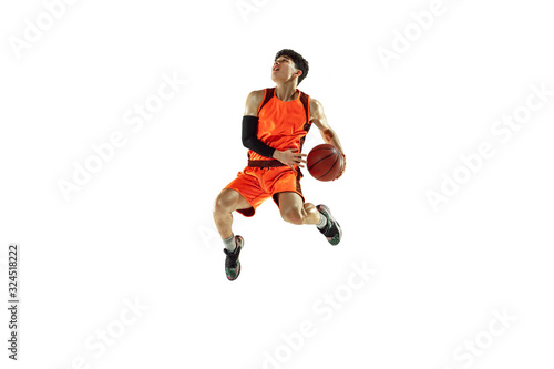 Young basketball player of team wearing sportwear training, practicing in action, motion in jump, flight isolated on white background. Concept of sport, movement, energy and dynamic, healthy lifestyle © master1305