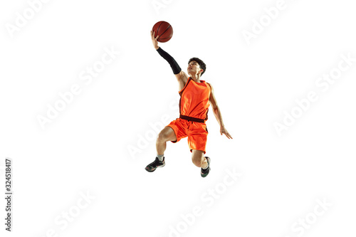 Young basketball player of team wearing sportwear training, practicing in action, motion in jump, flight isolated on white background. Concept of sport, movement, energy and dynamic, healthy lifestyle © master1305