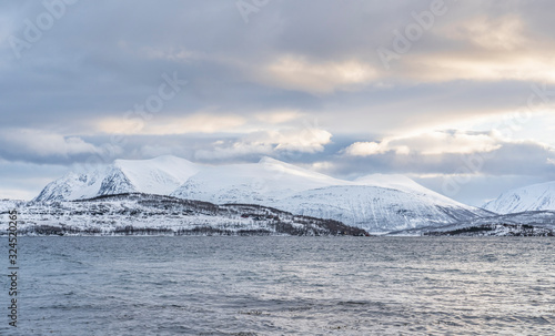 winter landscape at polar dawn on Kvaløya Island and fjord near Tromso, northern Norway © Uwe