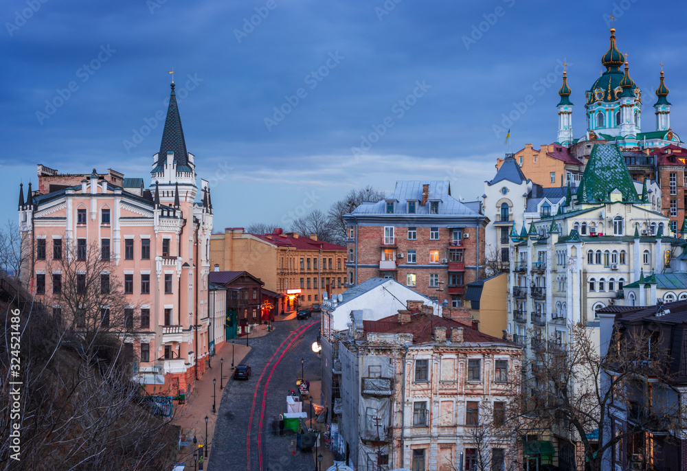 View to Old District Podil of Kyiv city from Zamkova Hill at sunset.
