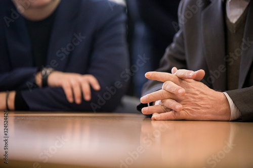 male hands on a wooden table.toned