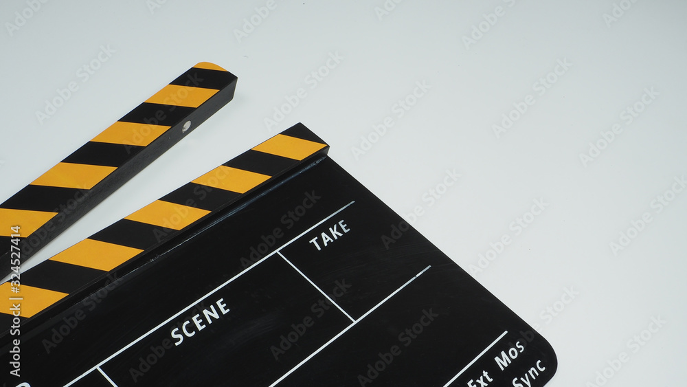 Naklejka premium clapperboard or Movie slate or clapper board in yellow and black color.It is used in video production and film industry on white background.