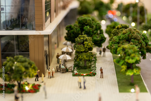 Miniature people enjoying in modern residential complex.