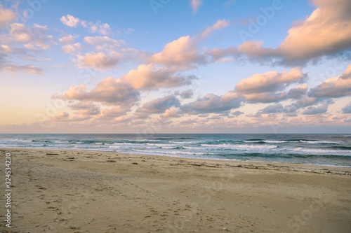 Colorful sky with clouds on the sea with beach