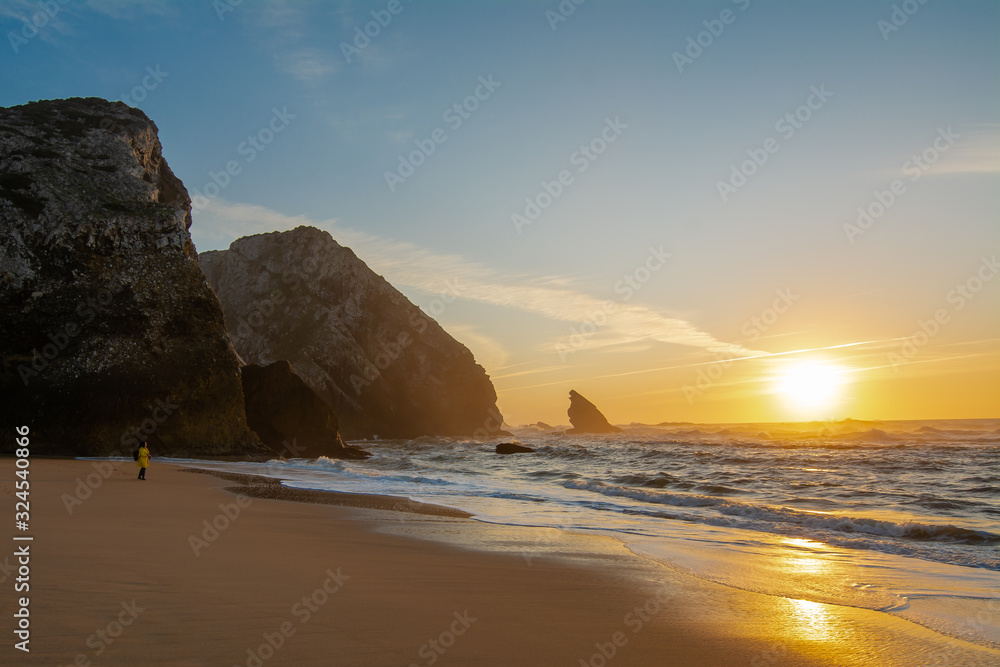 Walking in the beach at sunset in Sintra, Portugal