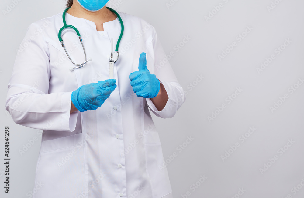 medic woman in white coat and blue latex gloves holds a syringe and shows like gesture medic woman in white coat and blue latex gloves holds a syringe and shows like gesture