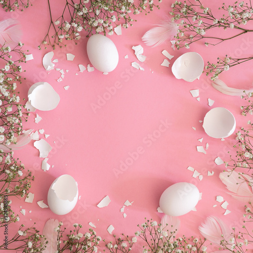 Happy Easter. Congratulatory easter background. Easter eggs with spring flowers gypsophila on a pink background