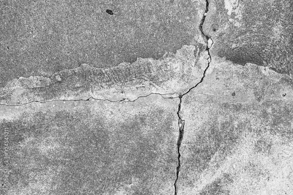 Obraz premium Black and white texture background floor of caraked cement garage.