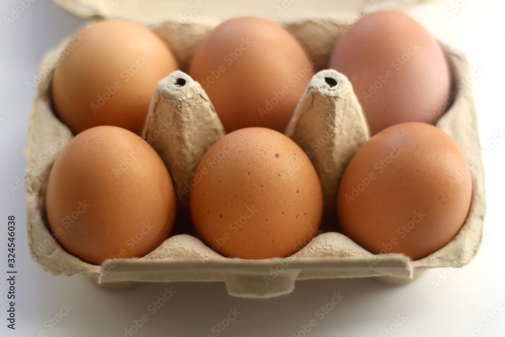 Free range eggs and gypsophila flowers on white background. Selective focus.