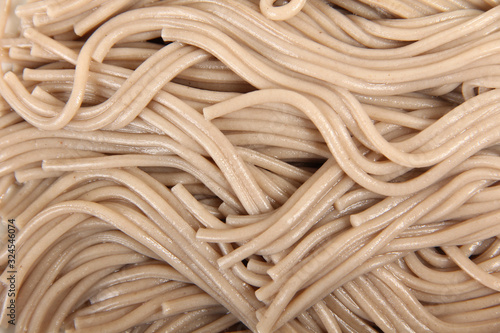 Boiled gray flour pasta on a porcelain plate
