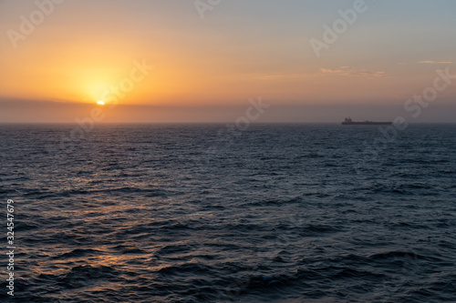 Ship moving past the sunset