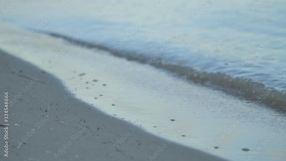 Water splashing sandy riverbank in winter Water splashing sandy riverbank in winter