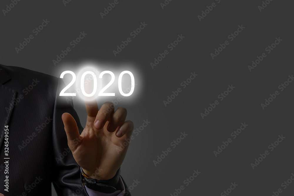 Luminous 2020 year numbers and network above man's hands at black background. New 2020 year technology concept. Luminous 2020 year numbers and network above man's hands at black background. New 2020 year technology concept.