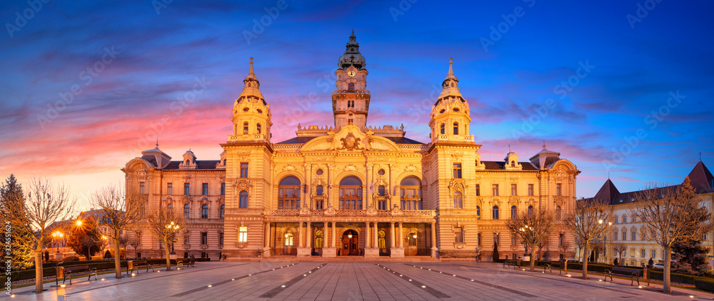 Gyor, Hungary. Panoramic cityscape image of Gyor downtown with Gyor Town Hall during beautiful sunrise.