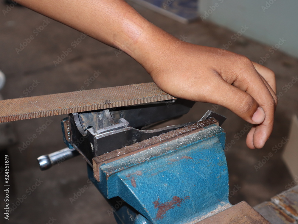 worker working on a vice grip worker working on a vice grip