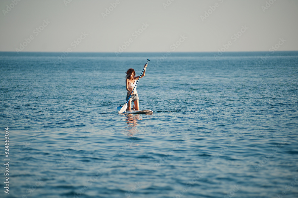 Stand Up Paddling in the sea. SUP. Women Training on Paddle Board Stand Up Paddling in the sea. SUP. Women Training on Paddle Board