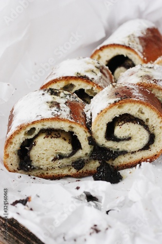 Delicious roll with poppy seeds on the table