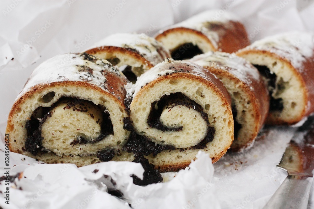 Delicious roll with poppy seeds on the table