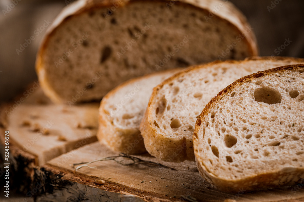 Freshly baked bread cut into chunks on a wooden Board Freshly baked bread cut into chunks on a wooden Board