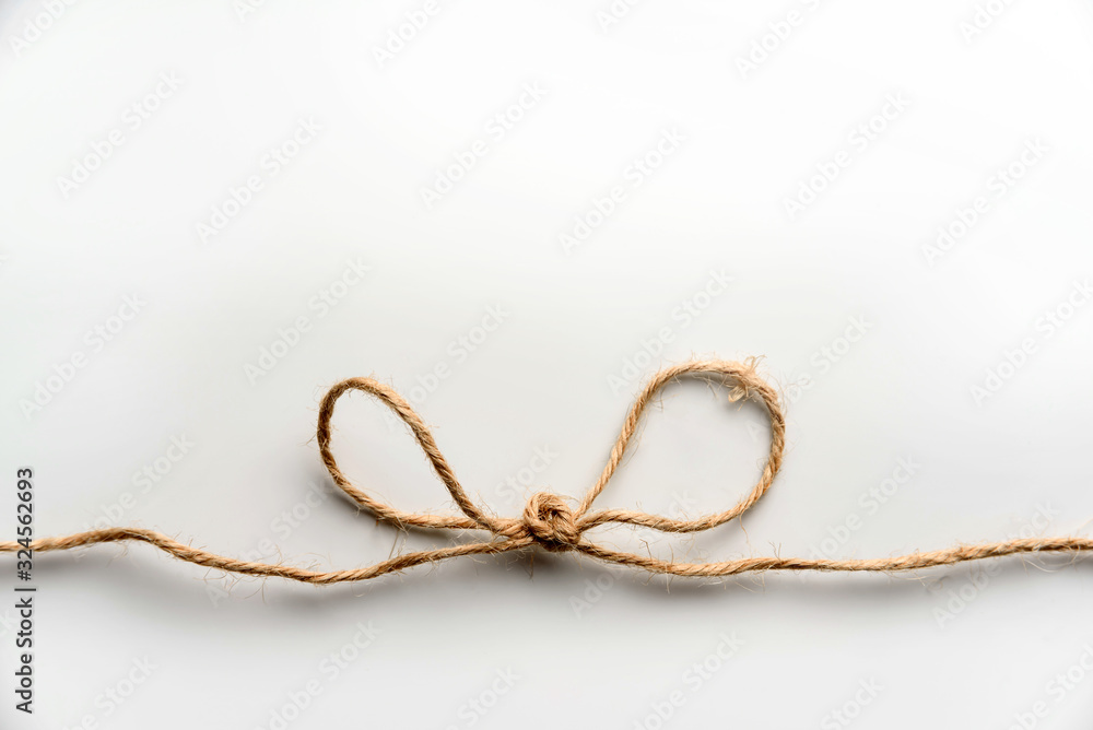 A bundle of rough hemp rope on a white background.