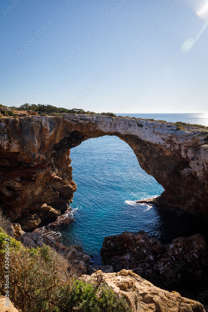 The stony arch in the Cala Varques lagoon The stony arch in the Cala Varques lagoon
