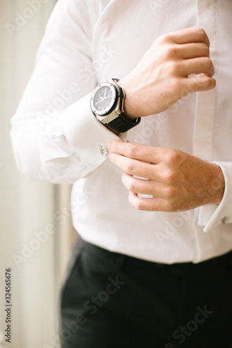 Groom's wristwatch and cufflinks. Suit.