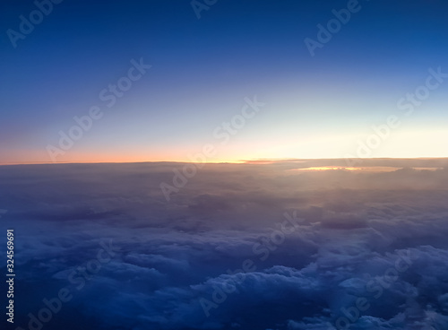 Amazing view of the sunrise over the clouds at dark night sky