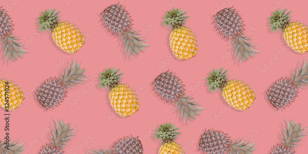 Pattern with pineapples on pastel background. Colorful fruit pattern of fresh pineapples on pink pastel background. Top view on pineapples. Pattern with pineapples on pastel background. Colorful fruit pattern of fresh pineapples on pink pastel background. Top view on pineapples.