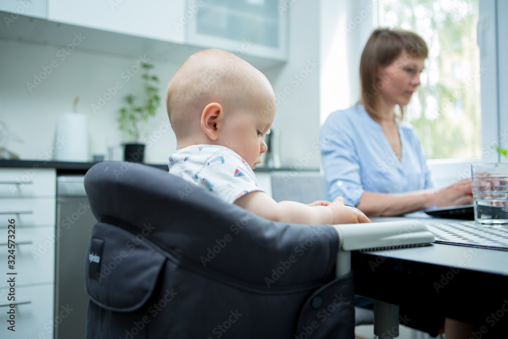 Home office. Mother with cute baby working from home Home office. Mother with cute baby working from home