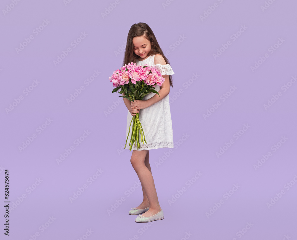 Pleased teen girl enjoying bouquet of flowers Pleased teen girl enjoying bouquet of flowers