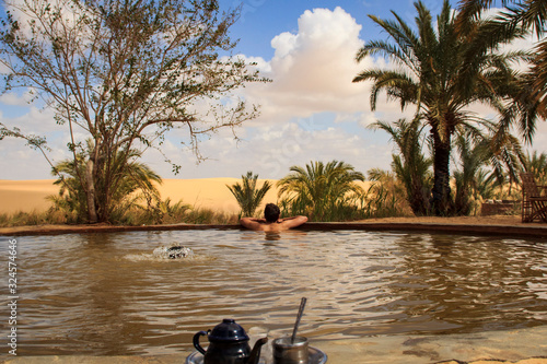 Siwa Oasis protected area, man enjoying hot spring in the Egyptian desert