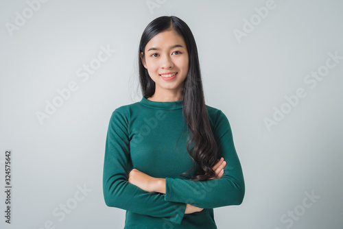 Beautiful young asian woman smiling and looking happily.