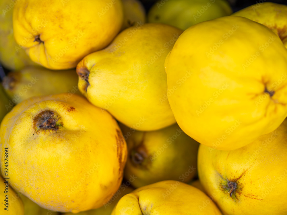 Close up fresh quince. Fresh, yellow Quinces in baskets on sale at the market. Bio Food On A Health Food Store Counter