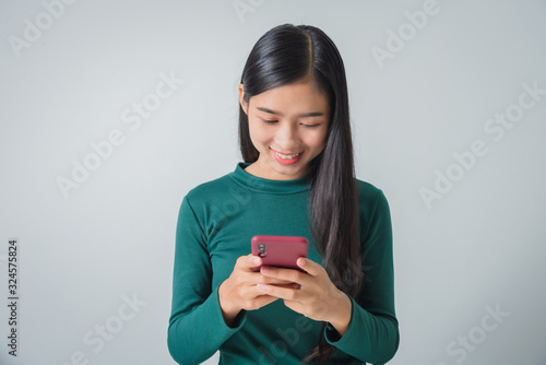 Shot of pretty young female holds modern smart phone amazed by unbelievable message winner, happy feeling.