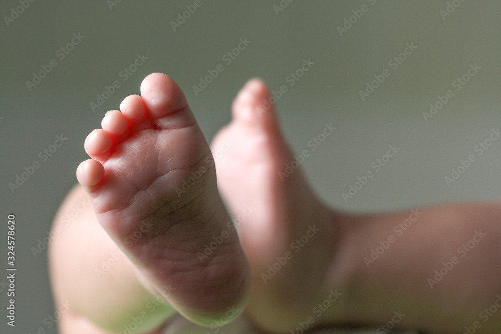 Close up of the tiny legs of a lying baby Close up of the tiny legs of a lying baby