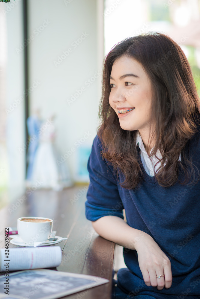 Business asian women sitting on sofa in cafe drink hot coffee Business asian women sitting on sofa in cafe drink hot coffee