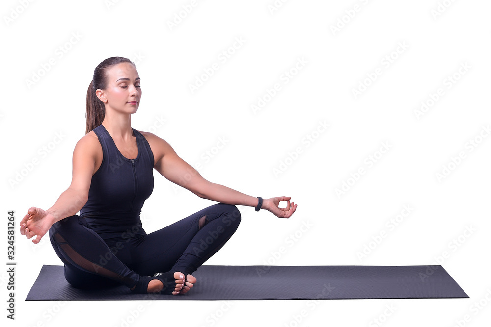 Fototapeta premium Beautiful girl isolated on white background doing yoga and meditating in lotus position.