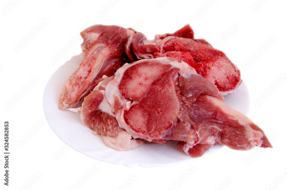 Raw meat on bones in a plate