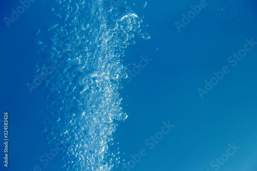 Water bubbles in the blue water .Abstract oxygen bubbles in the water.Water bubbles on blue background.