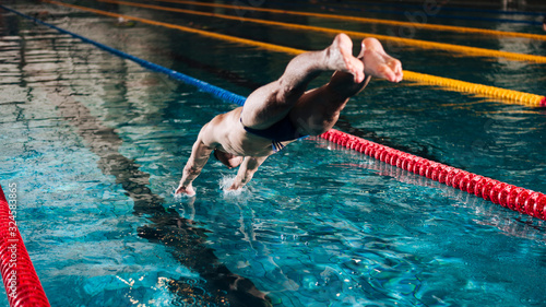High angle male swimmer diving in swimming pool