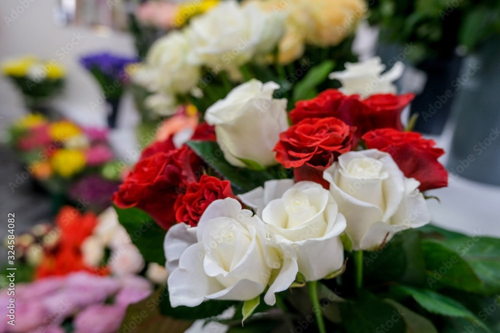 Bouquet with red and white roses. Close up of flowers..Beautiful floral background. Concept of holiday, presents, flower shop. Bouquet with red and white roses. Close up of flowers..Beautiful floral background. Concept of holiday, presents, flower shop.