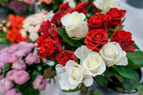 Bouquet with red and white roses. Close up of flowers..Beautiful floral background. Concept of holiday  presents  flower shop.