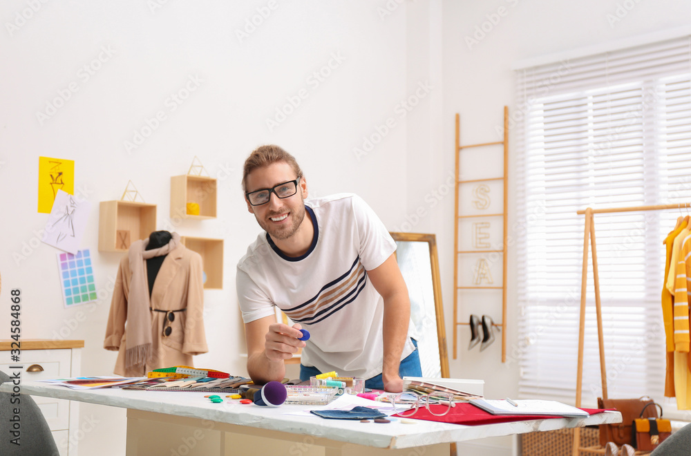 Fashion designer creating new clothes in studio Fashion designer creating new clothes in studio