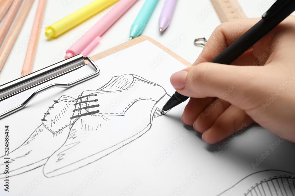 Fashion designer drawing shoes at table, closeup Fashion designer drawing shoes at table, closeup