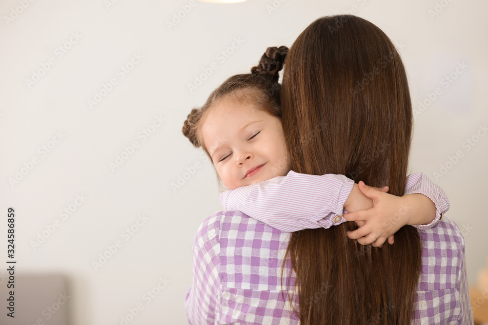 Young mother with little daughter at home. Space for text Young mother with little daughter at home. Space for text