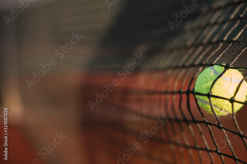 Tennis ball hitting net. Close-up.
