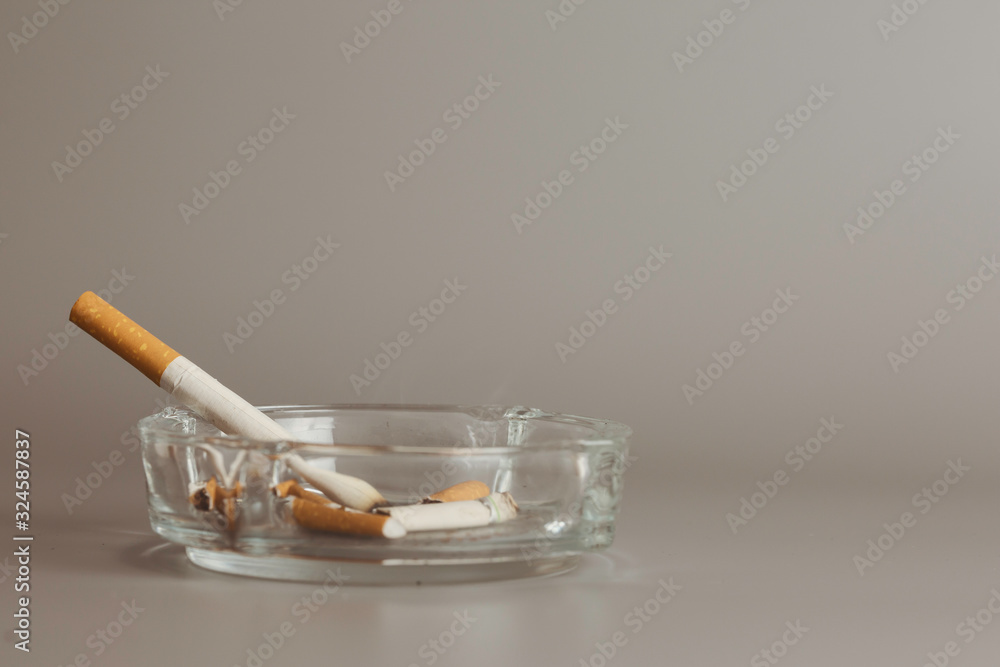 Cigarette in ashtray is addictive to be cancer.smoking reduction campaign in World No Tobacco Day. Cigarette in ashtray is addictive to be cancer.smoking reduction campaign in World No Tobacco Day.